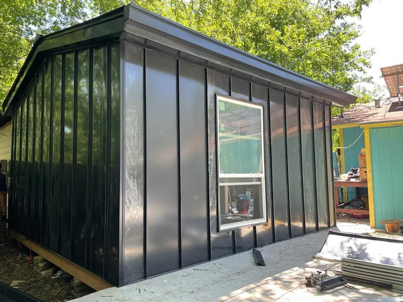 Black standing seam metal wall panels for Roof Inspection in The Crossings