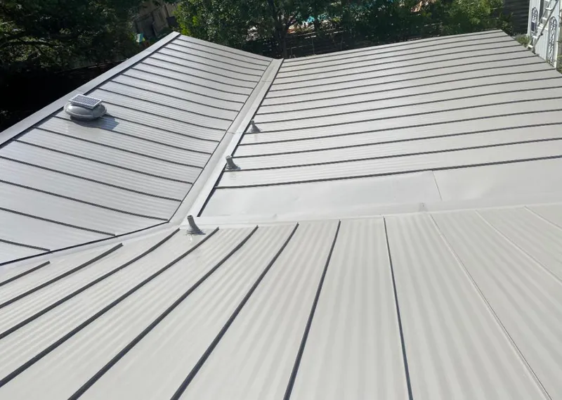 Solar attic fan installed on a metal roof for Roof Ventilation in The Crossings